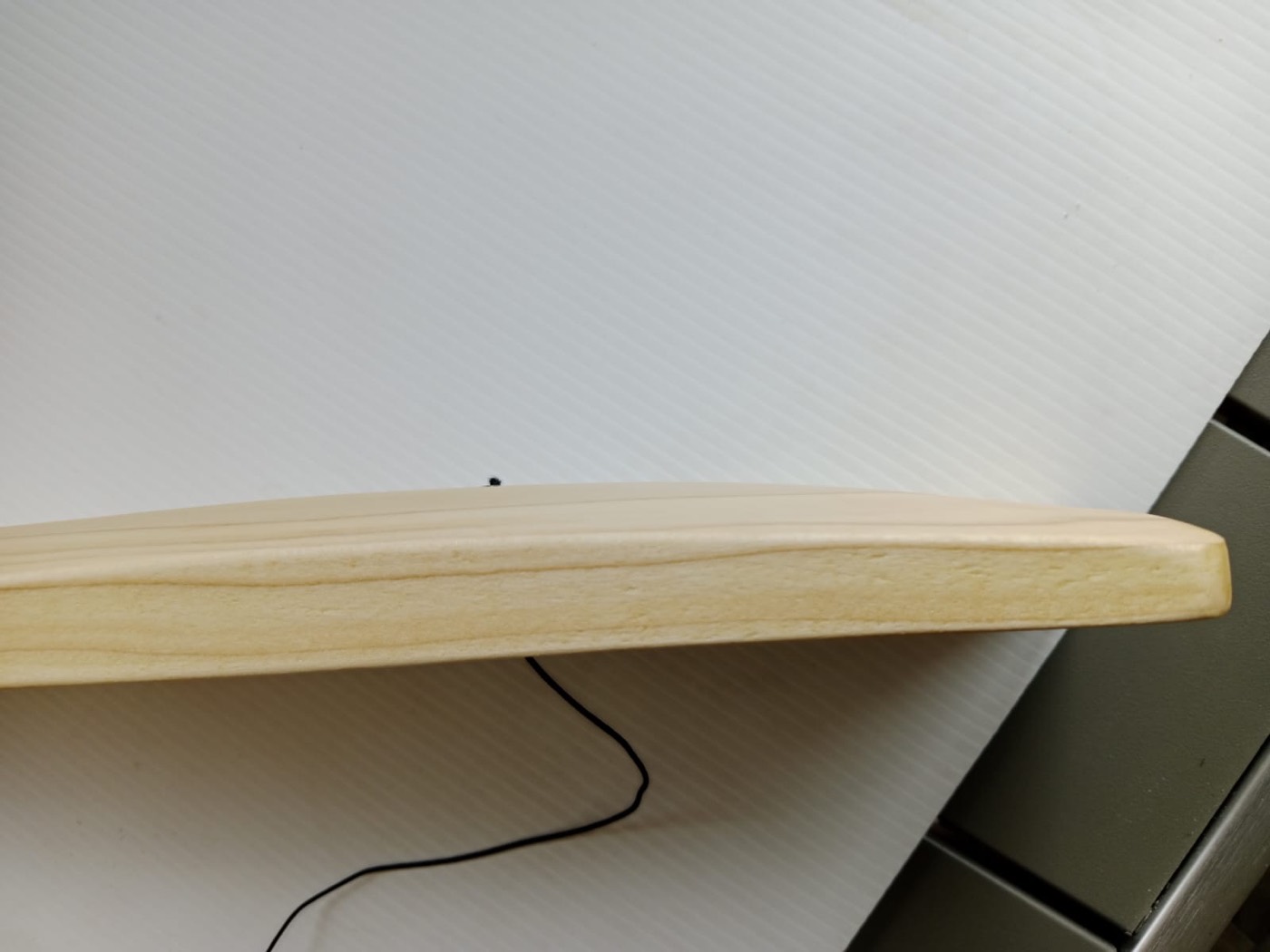 Close-up of the hand-sanded rounded edge of a bat blade