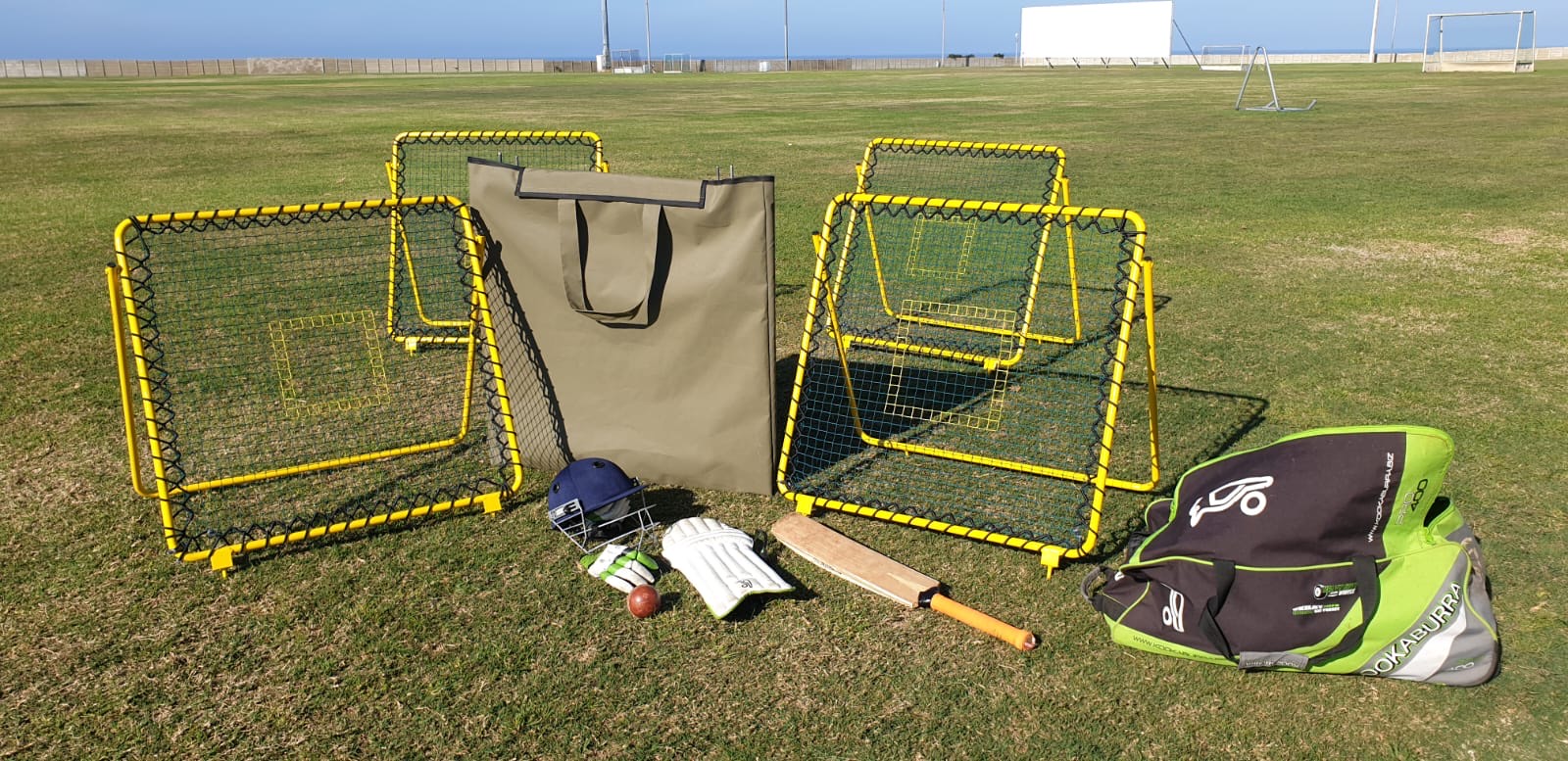 Catch-It Trainer rebound nets set up on a cricket field with kit