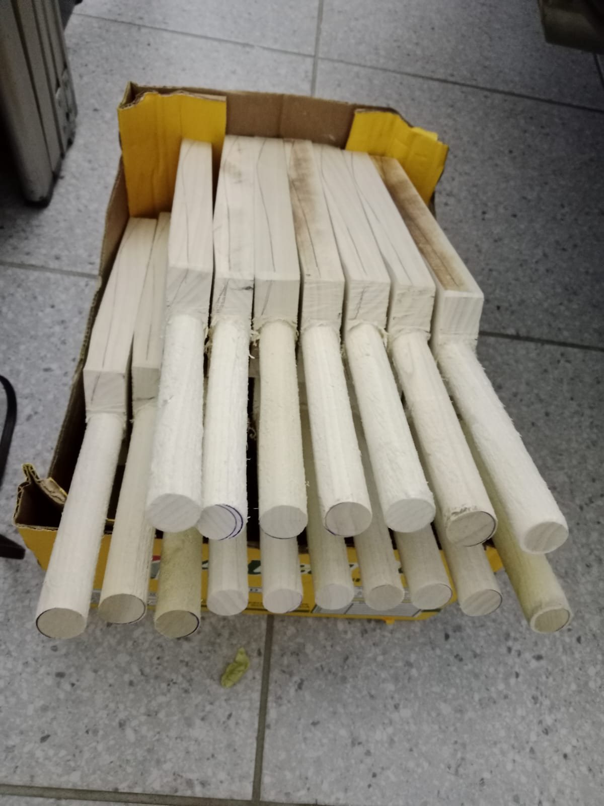 A cardboard box filled with cut KiTi-Bat blanks